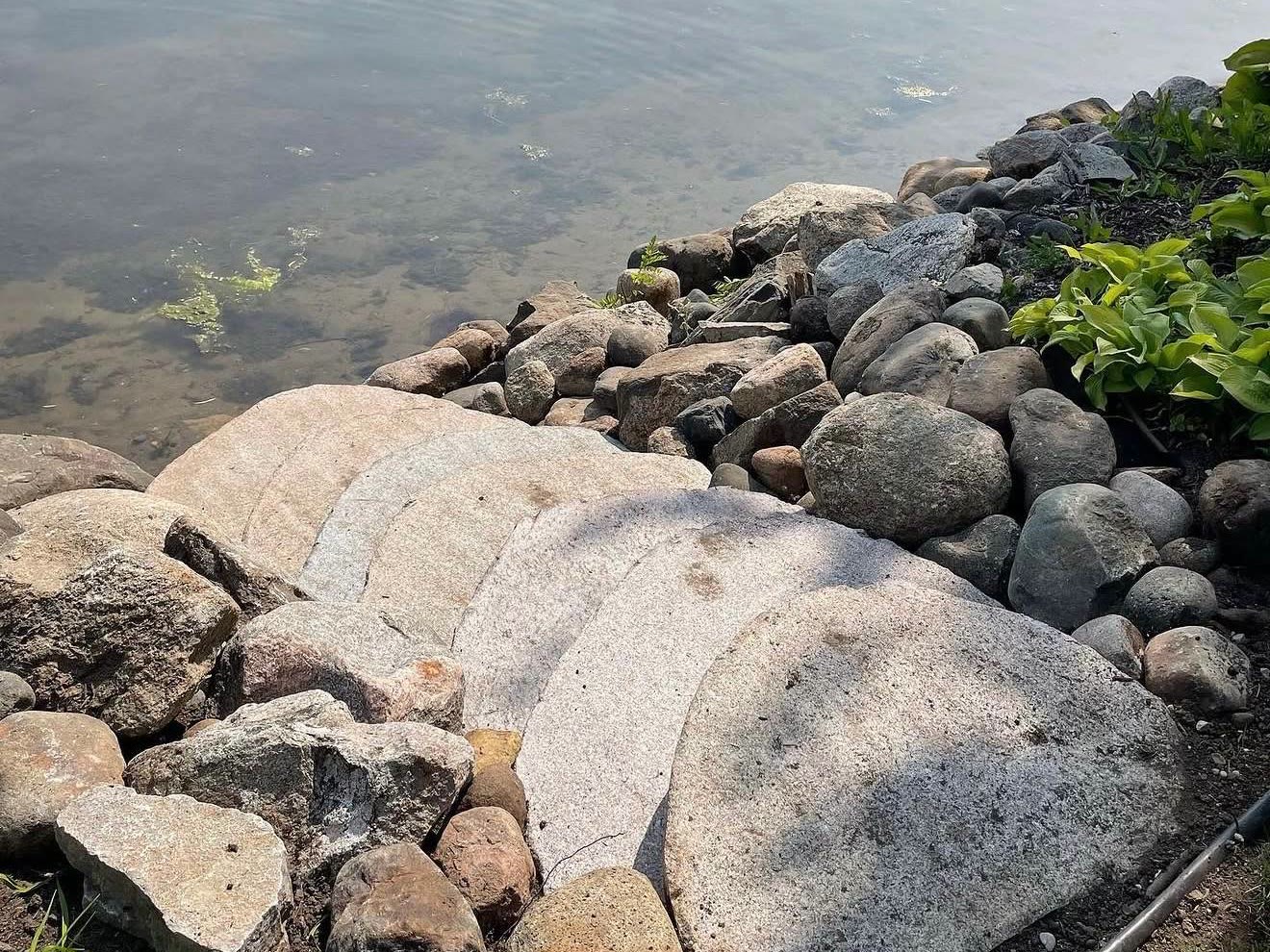 Finished natural stone steps and riprap shoreline